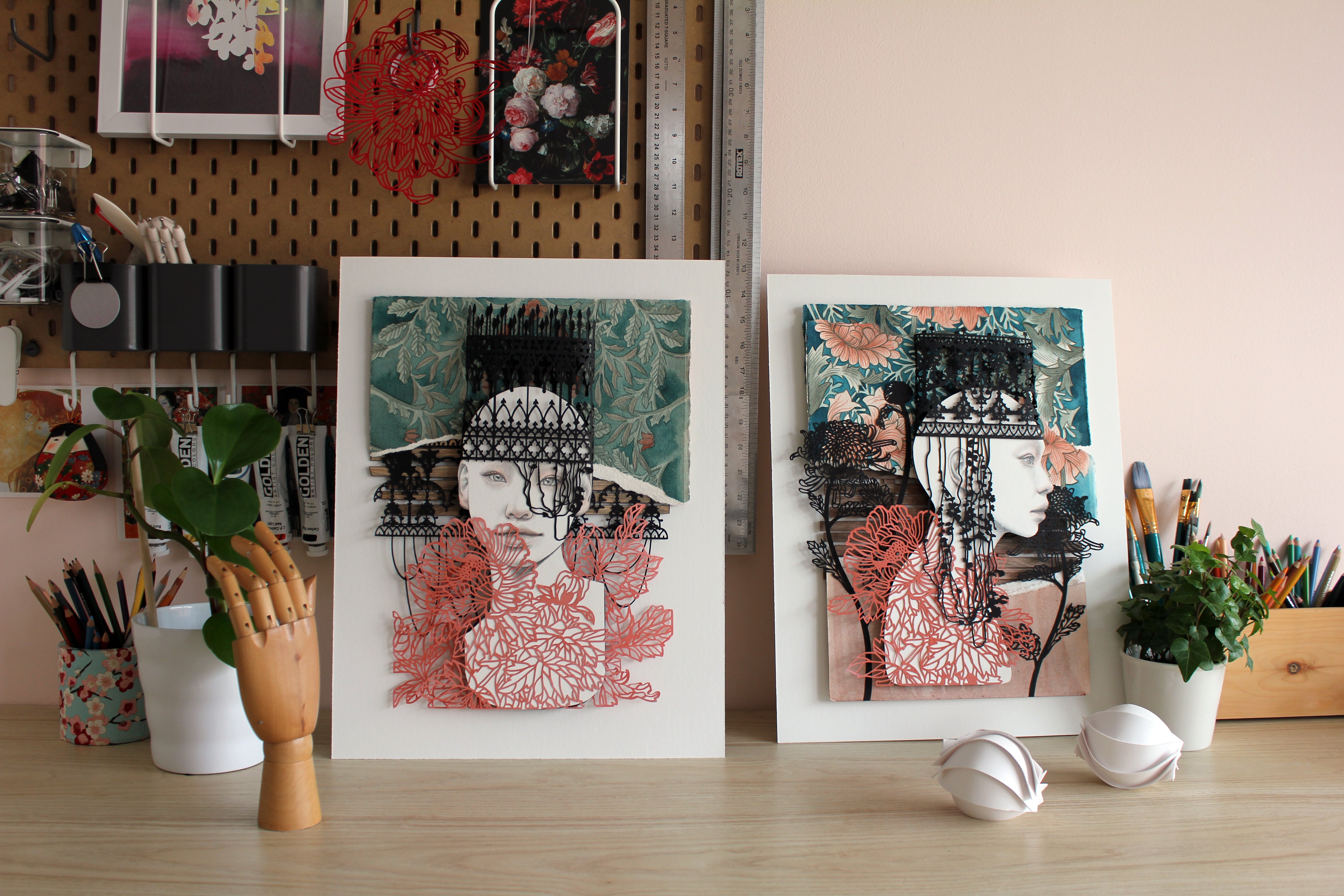 By Heart by Christine Kim – Two framed artworks on a desk with decorative items.