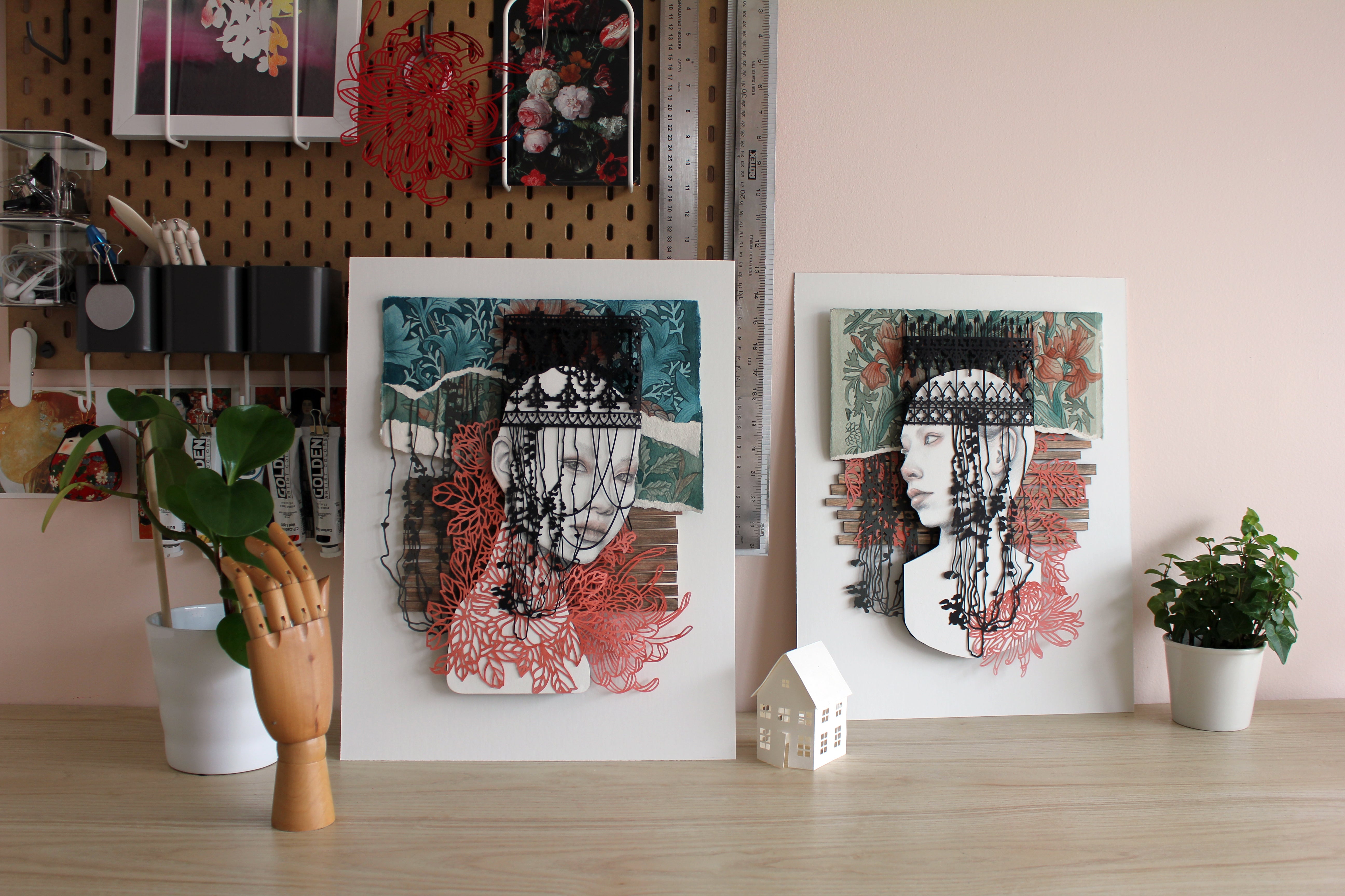 Christine Kim – Two abstract art pieces on a desk with decorative items.